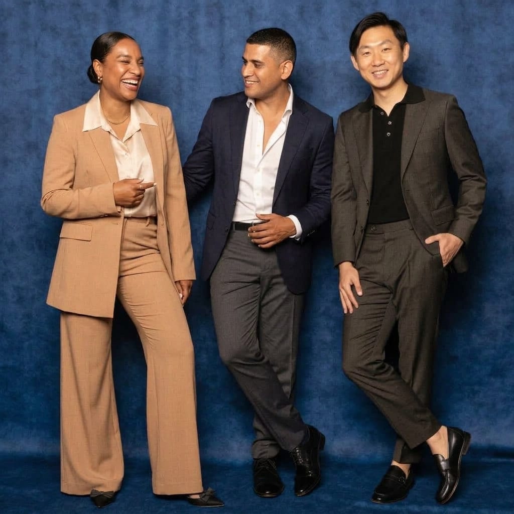 Colleagues in suits against a deep blue backdrop at a company event
