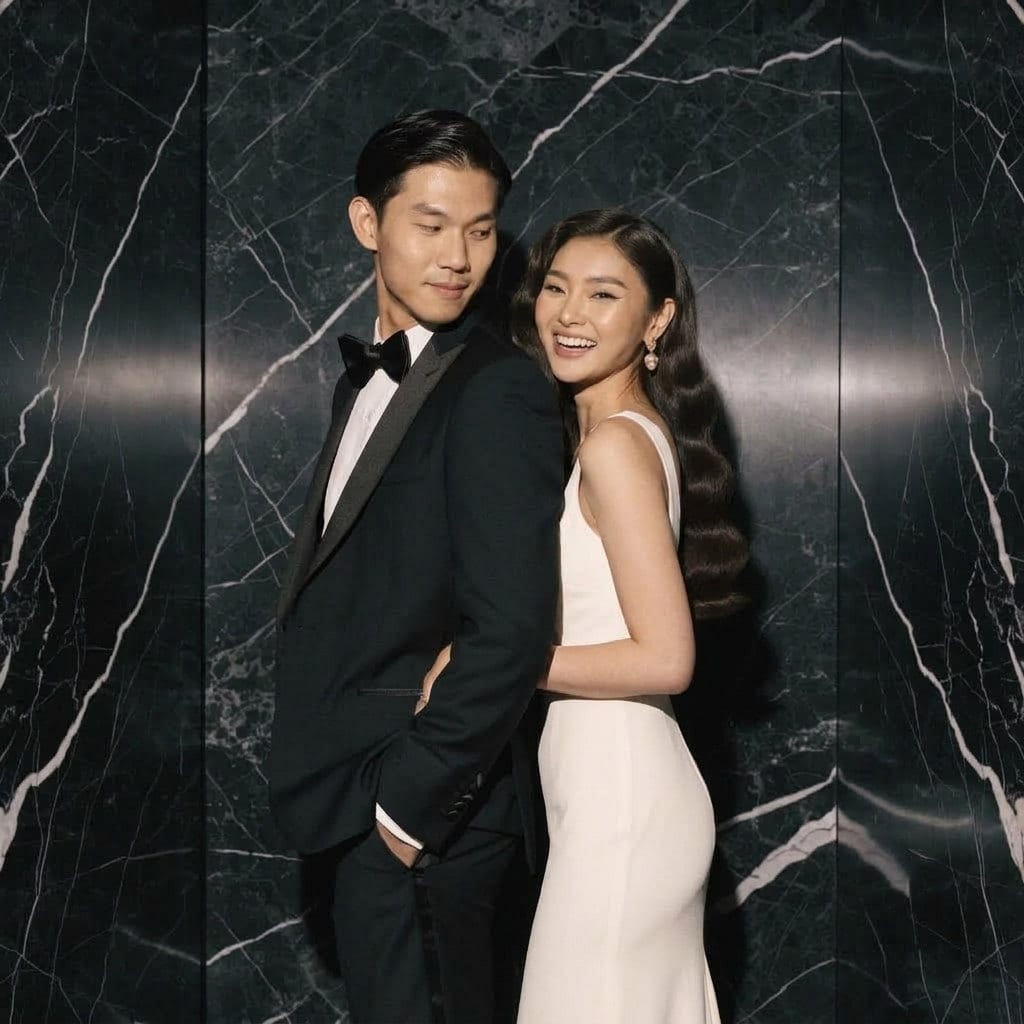 A couple in black tie against a dark marble backdrop